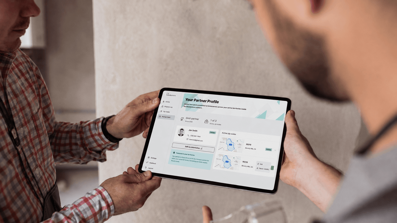 Two people reviewing a ReadilyHome partner profile on a tablet