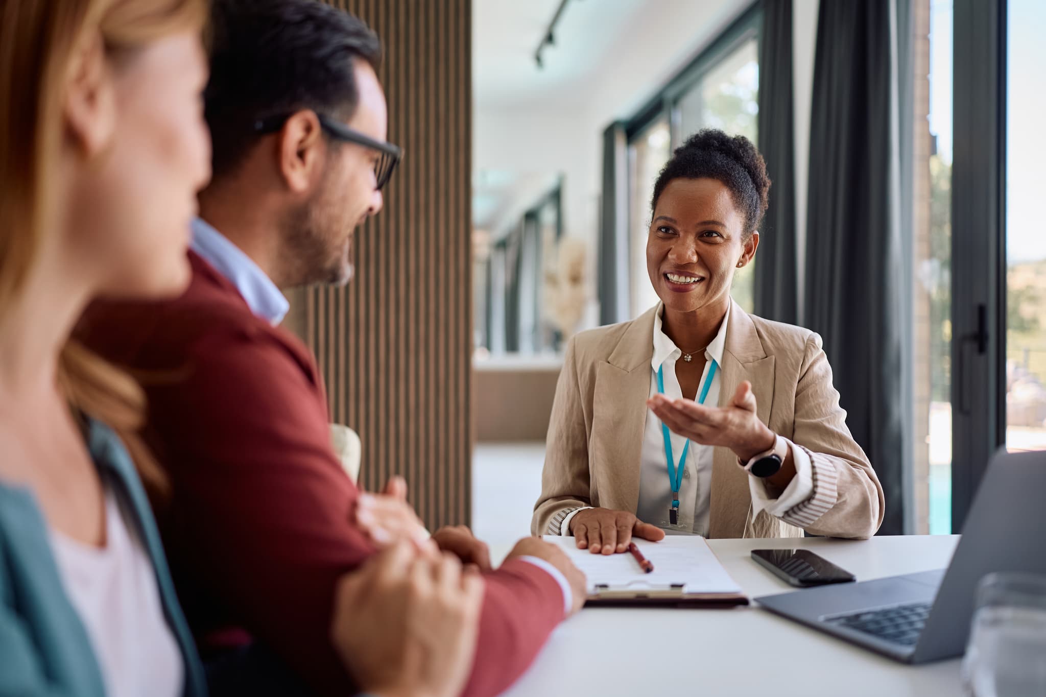 Insurance agent meeting with a couple in a modern office