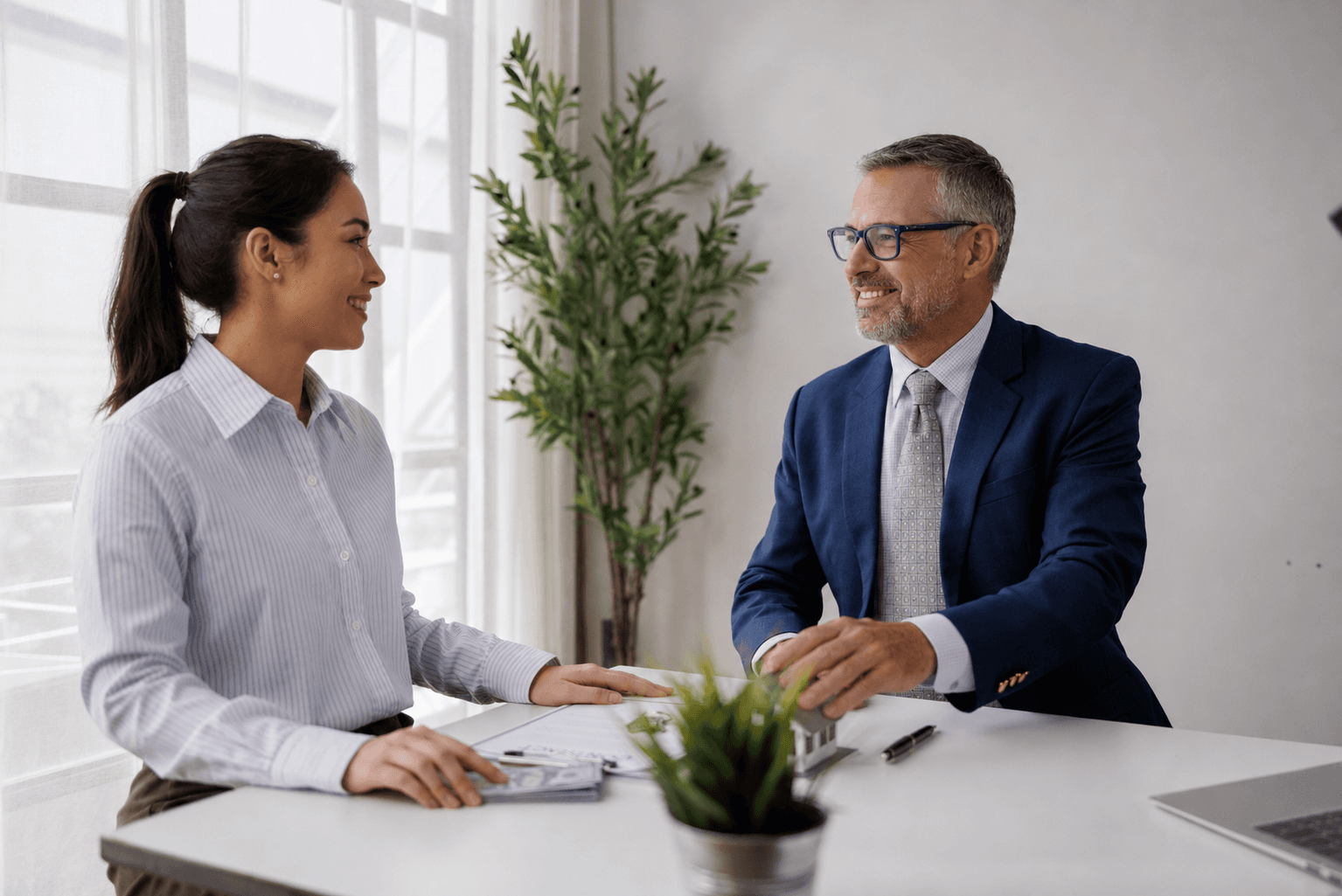 Mortgage loan officer meeting with a client at a desk
